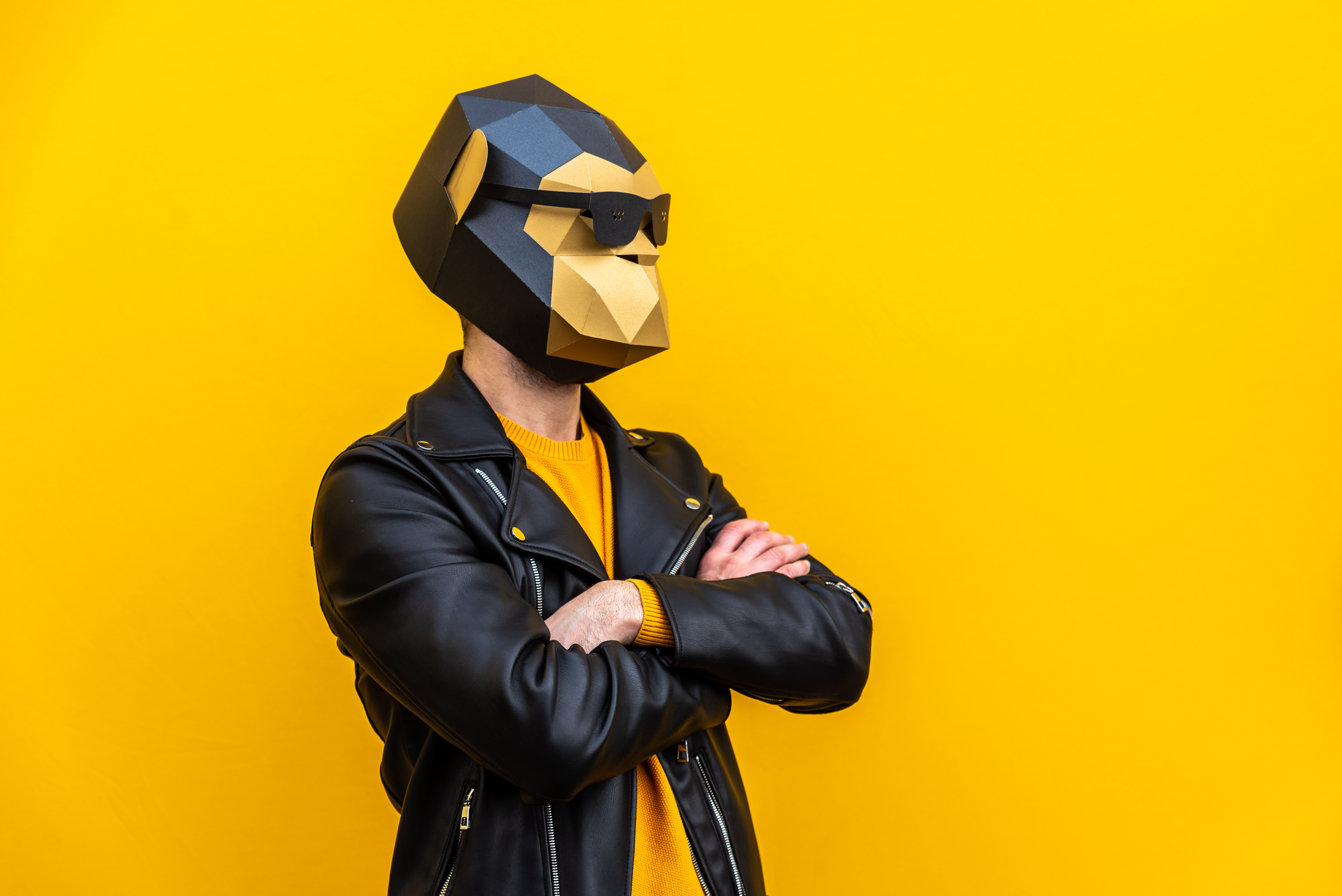 Happy man with funny low poly mask on colored background - Creative conceptual idea for advertising,adult with low-poly origami paper mask doing funny poses